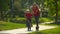 Slow motion shot of a young woman teach her little son how to ride a bicycle