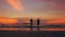 Slow motion silhouette of happy loving couple kiss and go to beach on sunset in ocean shore