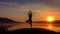 Slow motion silhouette of a young girl trains yoga in the sunset, mountains background.