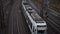 Slow motion: silver train passing with power lines in Kassel, Germany Daylight