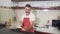 SLOW MOTION singing in kitchen - attractive man in red apron singing song and dancing crazy happy holding spoon as if playing drum