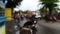 Slow motion slomo of defocused bokeh blur footage of asian indonesian street at afternoon after rain with bike and car passing by