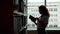 Slow motion of smiling student choosing book in school library reading