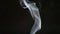 SLOW MOTION: Smoke steam into cigarette smoke on a black background