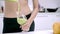 Slow motion - Sporty Asian woman drinking apple juice in kitchen, beautiful female in sport clothing use organic fruits.