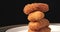 slow motion stock footage,  rotating and close up nuggets chip fries stack on white plate. party snack fast food concept.