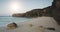 Slow motion of sun light sand beach, ocean waves aerial view. Water slowly run to sandy sea coast