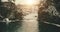 Slow motion sunrise at winter river aerial. People stand on bridge. Water flow at snow, ice shore