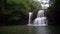 Slow motion of Thailand waterfall with tropical forest background.