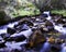 Slow-motion time-lapse of blurry running water landscape river and green rainforest along Santa Cruz Trek near Huaraz, Peru