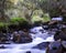 Slow-motion time-lapse of blurry running water landscape river and green rainforest along Santa Cruz Trek near Huaraz, Peru