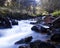 Slow-motion time-lapse of blurry running water landscape river and green rainforest along Santa Cruz Trek near Huaraz, Peru