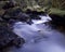 Slow-motion time-lapse of blurry running water landscape river and green rainforest along Santa Cruz Trek near Huaraz, Peru