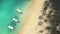 Slow motion top down sand beach with boats, tourists aerial view. Resting travelers at ocean bay