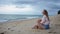 Slow motion translator young woman relaxing at sand sea beach