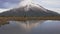 Slow motion - traveler wlking cross view to the taranaki volcano in the north island of new zealand and with the