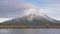 Slow motion - traveler wlking to the view looking to the taranaki volcano in the north island of new zealand and with