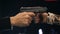SLOW MOTION: Two male hands with guns take aim at each other