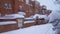 Slow motion urban landscape of residential area with houses covered in snow by storm Philomena. Tres Cantos, Madrid, Spain