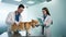 Slow motion vet nurse writing notes from male veterinarian palpating Corgi dog