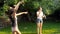 Slow motion video of beautiful young woman blowing soap bubbles with her daughters at park