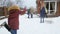 Slow motion video of children having snow ball fight at house backyard