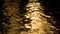 Slow motion video clip of golden light reflecting on sea, lake or river water with liquid gold ripples and reflections