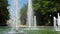 Slow motion video of fountain in urban park. Summer refreshment