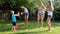 Slow motion video of happy family splashing water on each other at backyard garden