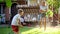 Slow motion video of teenage girl having water battle with little boy using garden hose and water gun