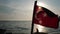 Slow motion video of the Turkish flag flapping at the back of a boat in Turkey.