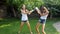 Slow motion video of two cheerful laughing girls splashing and pouring water over each other from plastic bottles