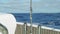 Slow motion view of Atlantic with long waves in sunny afternoon from stern of yacht