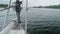 Slow motion view from yacht fore on river-bank and water. Close up of bowsprit and jib furler