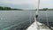 Slow motion view from yacht fore on river-bank and water. Close up of bowsprit and jib furler