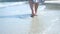 Slow motion walk of a lady at the beach. crystal clear sea. travel paradise.