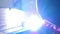 Slow motion welding. Welder worker welding metal. Bright electric arc and sparks during manufacture of metal equipment.