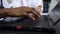 Slow motion of well-maintained dark-skinned male hands which typing on the computer keyboard