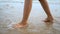 Slow motion woman feet walking on the sand beach with nature sea wave coast for summer vacation concept