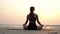 Slow motion of woman practice yoga lotus pose to meditation with summer vacation on the beach