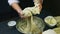 Slow motion of woman slowly kneads by hands soft yeast dough in deep metal bowl