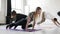 Slow motion woman standing in plank pose, coach helps and corrects