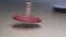 Slow motion wooden spinning top in action