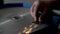 Slow-motion, worker sharpens a clipper blade on grinding machine, sparkles in slow-motion