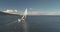 Slow motion yacht sail cruising at wind aerial. Sailboat reflect at ocean water. Mountain coast