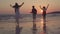 Slow motion - Young Asian people running on beach to the sea, friends happy relax having fun playing on beach near sea when sunset