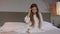 Slow Motion Young Attractive Woman in White Bathrobe Smiling, Straighten Hair