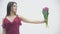 Slow motion of young beautiful woman holding a spring bouquet and enjoying the scent of fresh flowers.