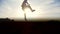 Slow-motion - young male Parkour tricker jumper performs amazing flips in front of the sun