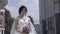 Slow motion young pretty woman holds purple wedding bouquet